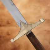 Close-up of the Ancient Persian Sword Replica featuring a polished brass crossguard, curved steel blade, and traditional wooden grip inspired by historic Persian weaponry.