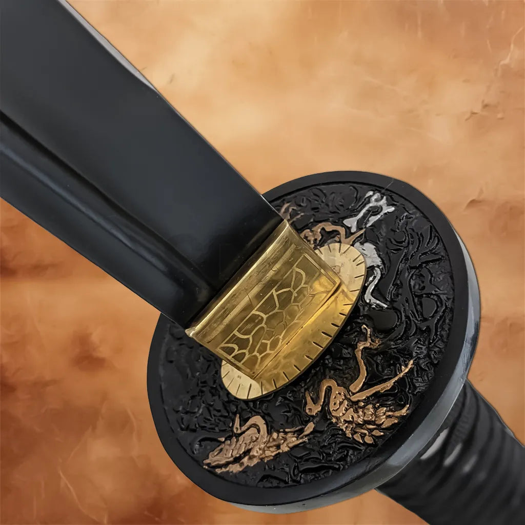 Close-up of the Japanese katana's black decorative guard with gold accents and a black blade.
