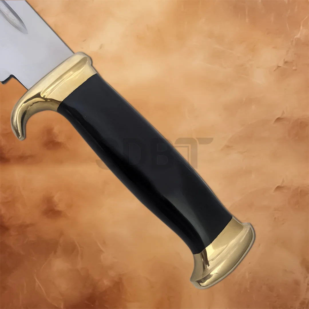 Detailed view of the Crocodile Dundee Bowie Knife Replica showing the glossy black grip, brass guard, and matching pommel for a classic look.