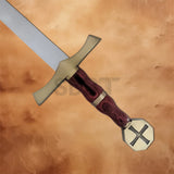 Detailed view of the Knights Crusader Cross Sword Replica featuring the brass crossguard, wood-grain handle, and engraved cross pommel.
