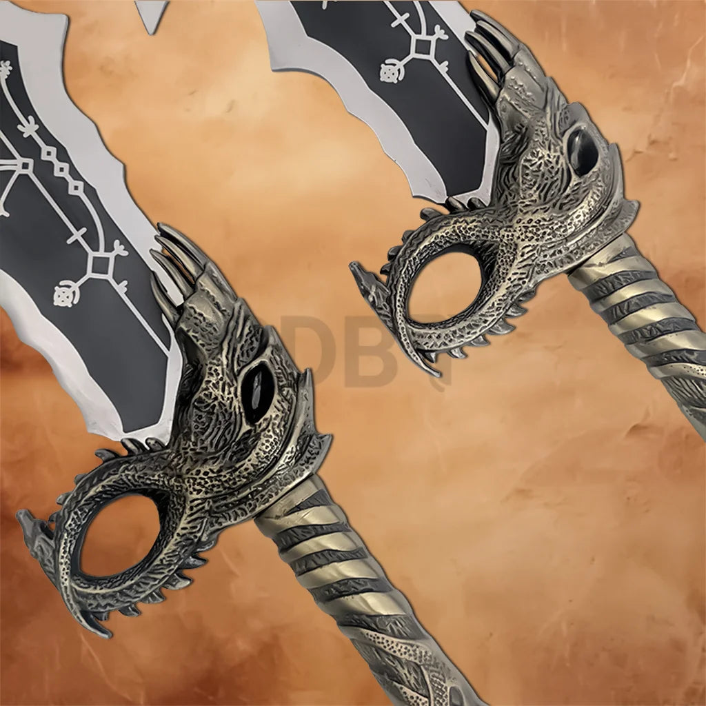 Close-up of the Kratos Blades of Chaos replica handles featuring dragon-inspired guards, engraved details, and weathered metallic finish.