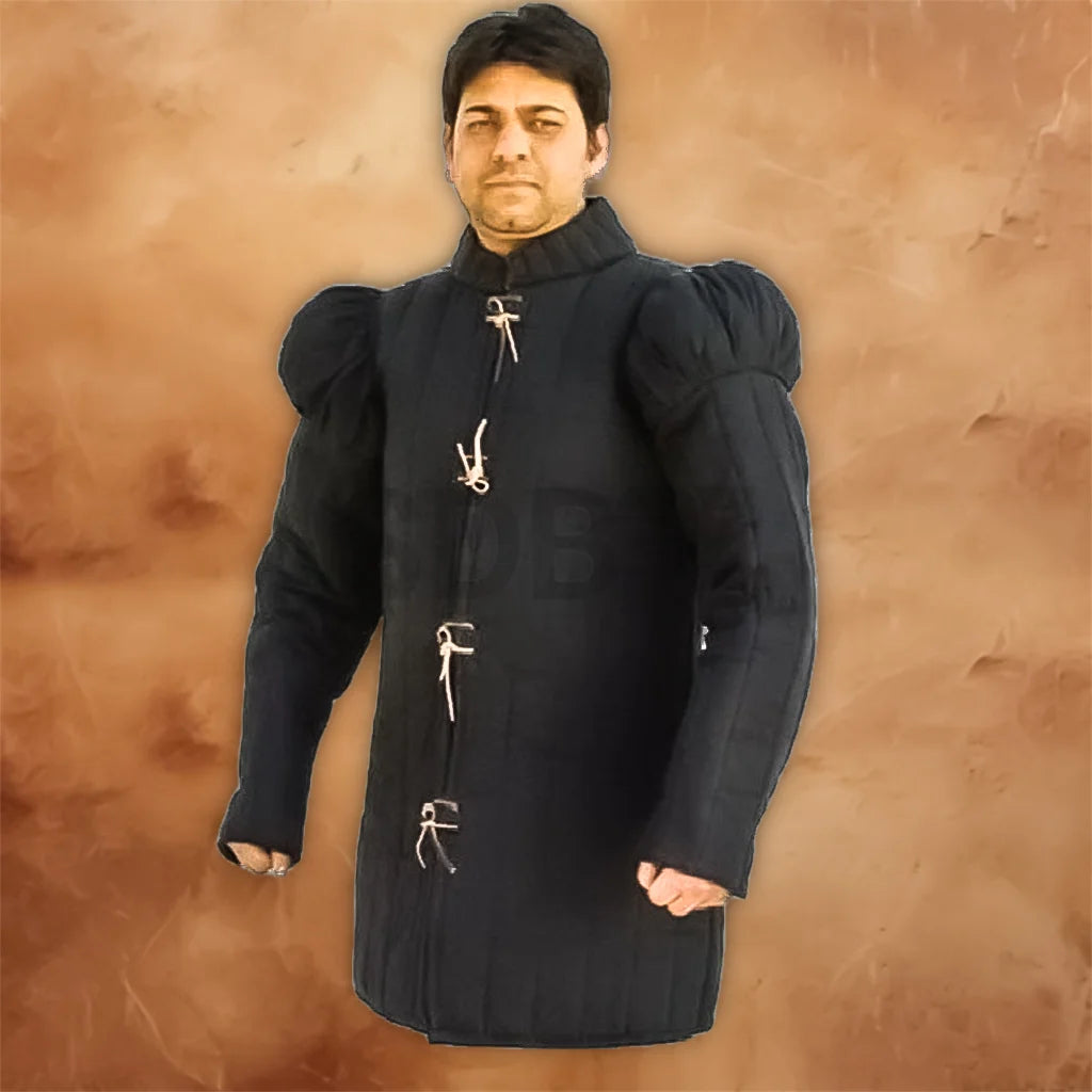 Medieval 15th century padded black gambeson costume displayed on a model, featuring long sleeves, raised shoulders, a high collar, and traditional front tie fastenings.