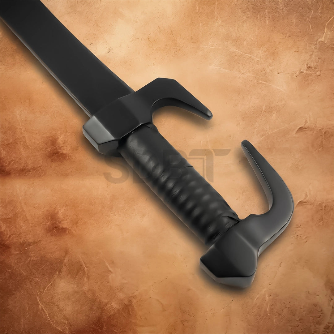 Close-up of the Spartan sword hilt showcasing the signature hooked guard, textured handle, and durable black finish.