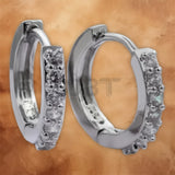 Detailed view of the crystal-set 925 sterling silver hoop stud earrings for women.