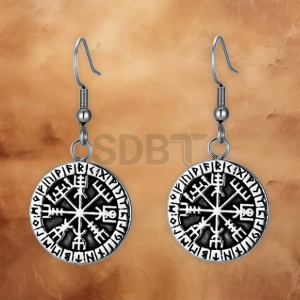 Angled view of Vegvisir drop earrings with an engraved Viking Compass design and polished stainless steel finish.