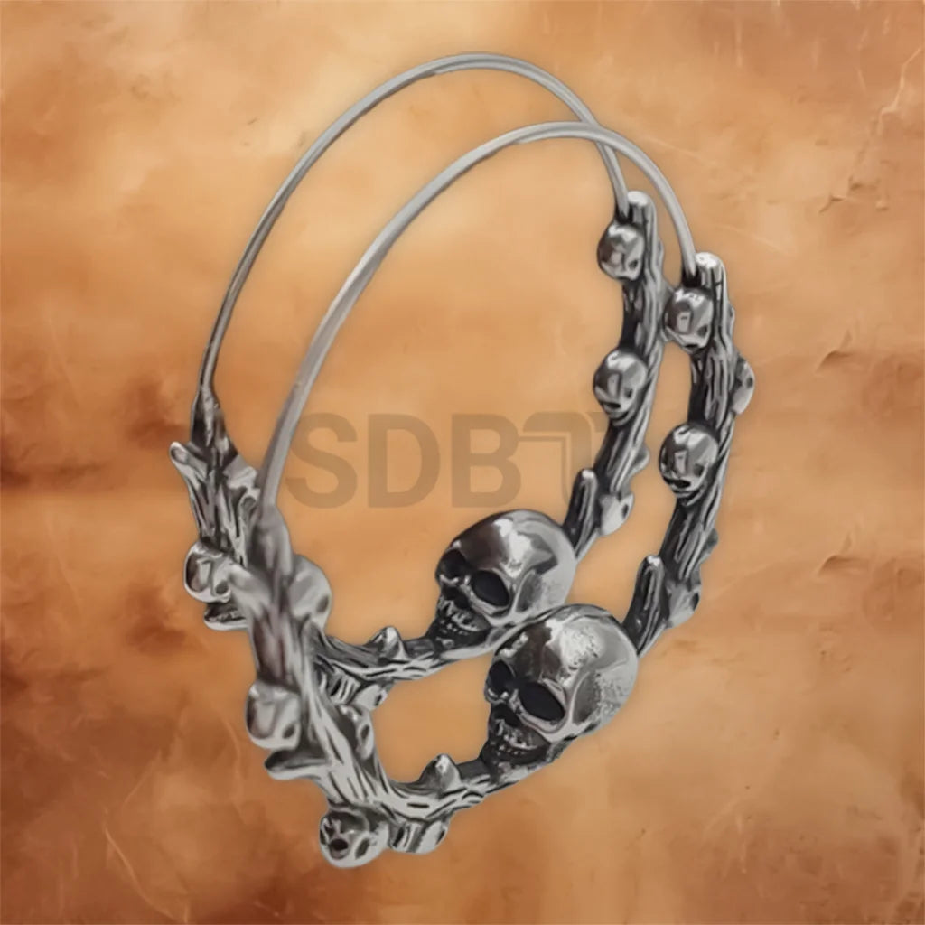 Close-up of Skull Vine hoop earrings showcasing detailed Viking Gothic engravings and stainless steel craftsmanship.