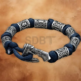 Close-up of the engraved Viking rune axe charm on the Norse Celtic paracord bracelet for men.
