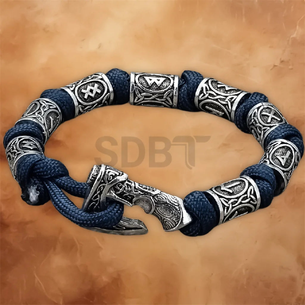 Close-up of the engraved Viking rune axe charm on the Norse Celtic paracord bracelet for men.