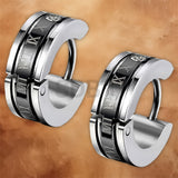 Detailed view of the engraved Norse rune pattern on stainless steel Viking hoop earrings for men.