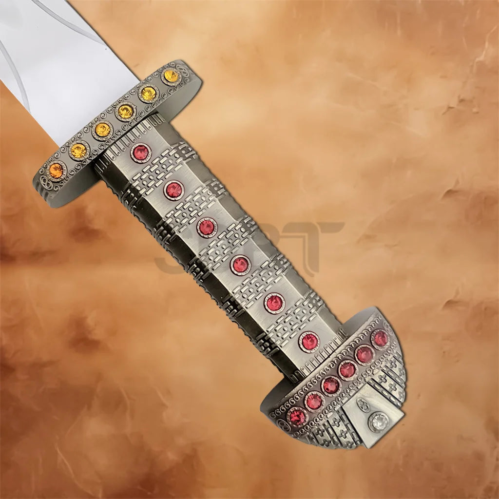 Close-up of the Viking Sword of Ragnar Lothbrok Replica Edition featuring a jeweled silver hilt with red gemstones and decorative crossguard